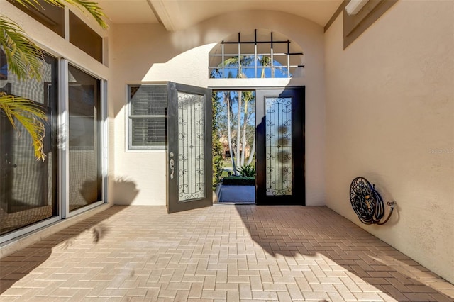 property entrance with stucco siding