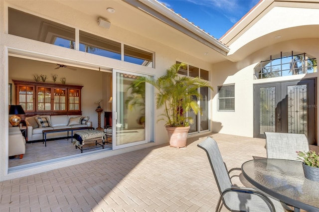 view of patio featuring an outdoor living space, french doors, and outdoor dining space