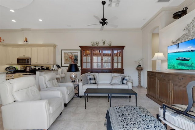 living area with light tile patterned floors, a ceiling fan, visible vents, recessed lighting, and crown molding