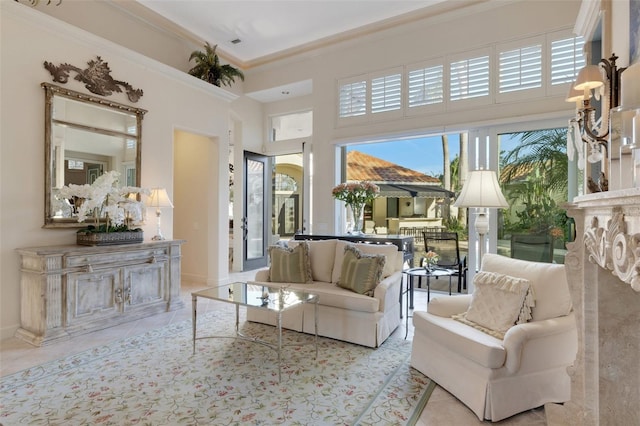 living area featuring tile patterned floors, a high ceiling, and ornamental molding