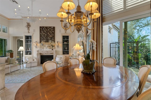 dining area with visible vents, a notable chandelier, a high ceiling, a fireplace, and tile patterned flooring