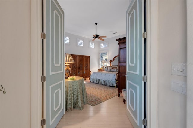 bedroom featuring light wood-style flooring and ceiling fan