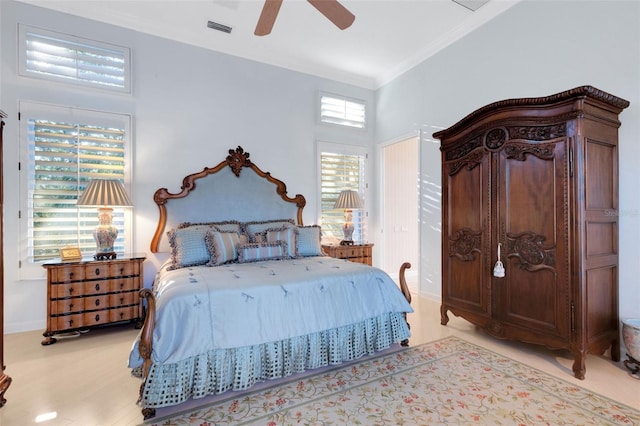 bedroom with ceiling fan, visible vents, ornamental molding, and light wood-style flooring