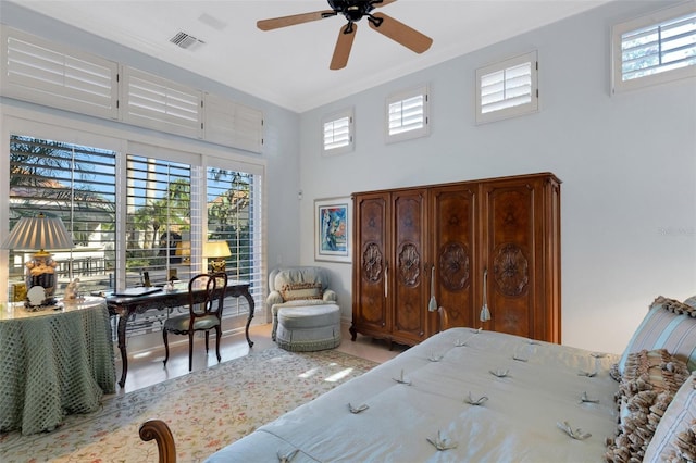 bedroom with visible vents, multiple windows, crown molding, and a ceiling fan