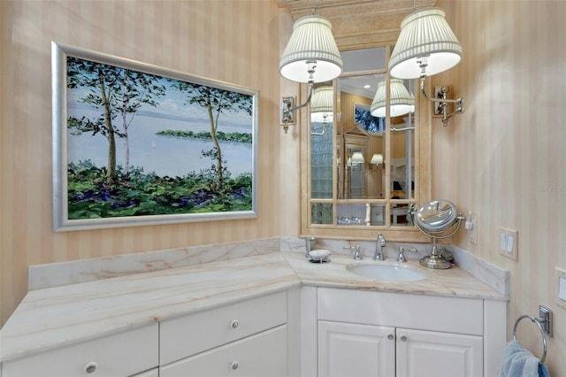 bathroom featuring wallpapered walls, vanity, and a water view