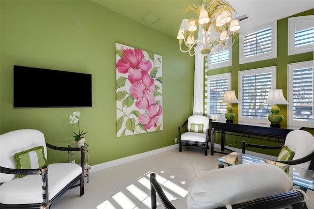 living area with tile patterned flooring, an inviting chandelier, baseboards, and visible vents