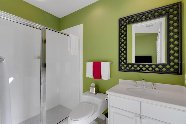 bathroom with vanity, a shower stall, toilet, and visible vents