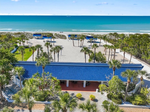 birds eye view of property with a water view and a view of the beach