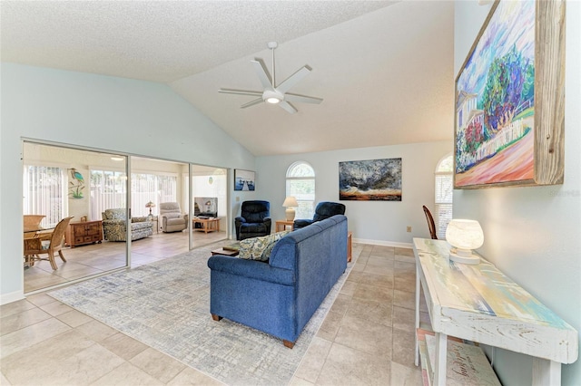 living room featuring high vaulted ceiling, a ceiling fan, a textured ceiling, light tile patterned flooring, and baseboards