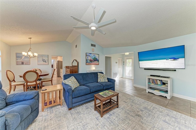 living room featuring baseboards, tile patterned flooring, vaulted ceiling, a textured ceiling, and ceiling fan with notable chandelier