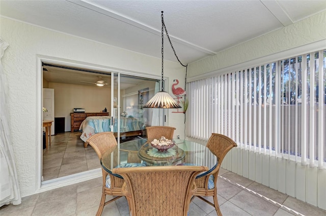 dining room featuring tile patterned floors, a textured ceiling, and a textured wall