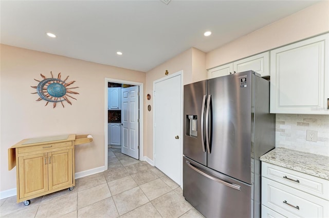 kitchen featuring decorative backsplash, light tile patterned flooring, stainless steel fridge with ice dispenser, and recessed lighting