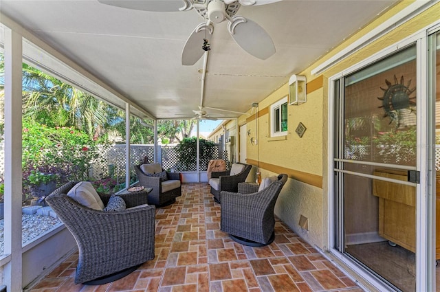 sunroom / solarium featuring a ceiling fan