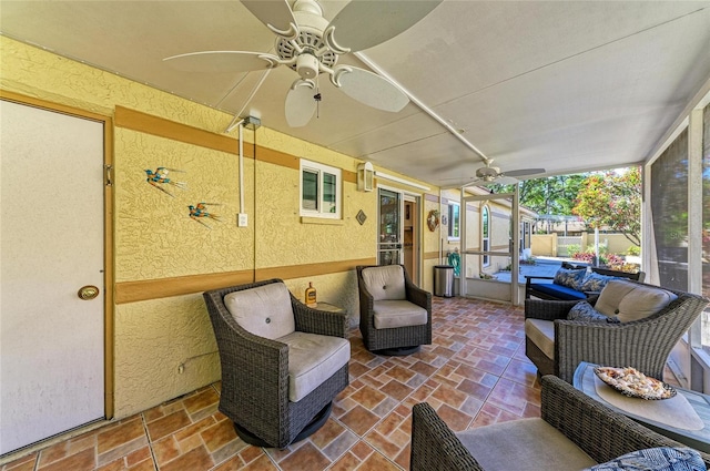 sunroom featuring a ceiling fan