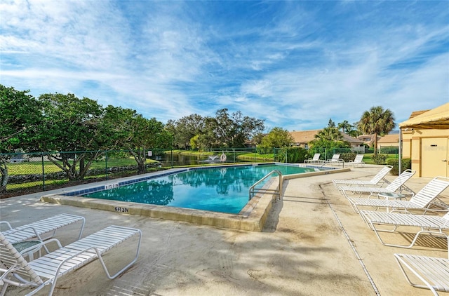 community pool featuring a patio and fence