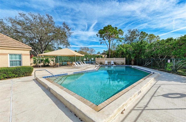 pool featuring a patio area and fence