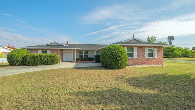 single story home with a front yard, brick siding, and driveway