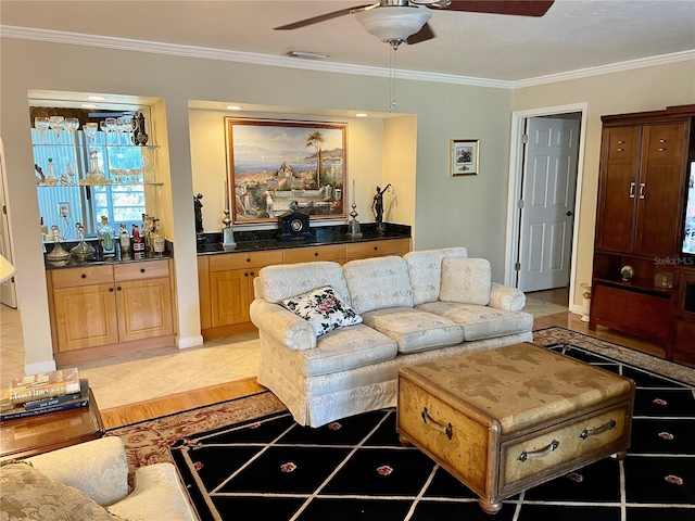 living area featuring visible vents, wet bar, ceiling fan, and ornamental molding