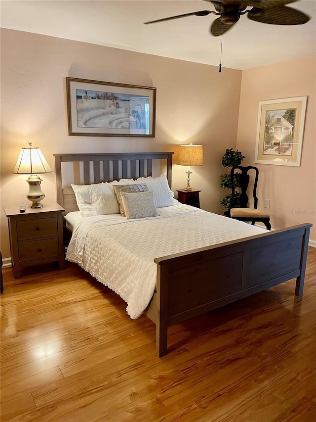 bedroom with ceiling fan and wood finished floors