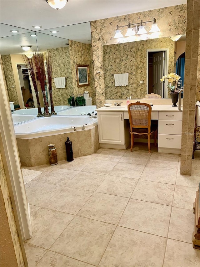 full bath featuring tile patterned flooring, wallpapered walls, vanity, and a garden tub