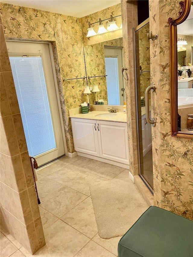 full bathroom with tile patterned floors, a stall shower, wallpapered walls, and vanity