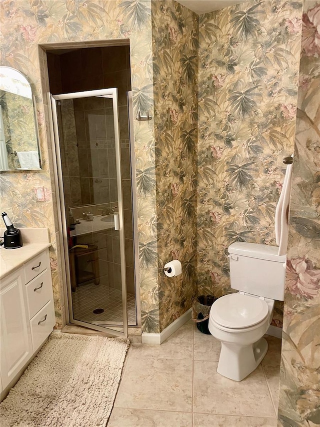 bathroom with toilet, a stall shower, wallpapered walls, baseboards, and vanity