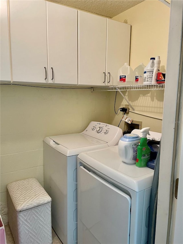 laundry room with cabinet space and separate washer and dryer