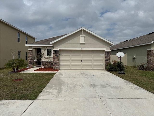 view of front of property featuring a front yard, stone siding, an attached garage, and concrete driveway