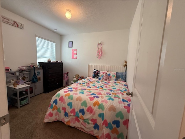 carpeted bedroom featuring a textured ceiling