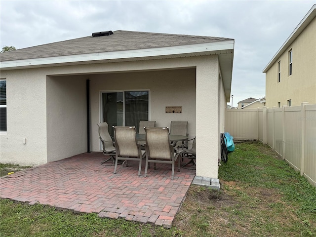 view of patio with a fenced backyard and outdoor dining area