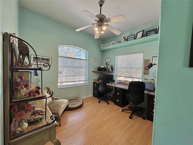 home office with baseboards, a textured ceiling, ceiling fan, and wood finished floors