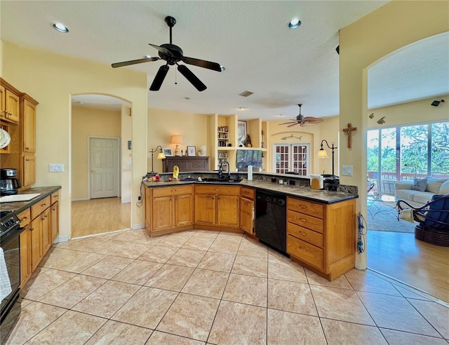 kitchen with arched walkways, dark countertops, dishwasher, and ceiling fan