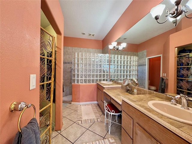 bathroom with tile patterned flooring, visible vents, walk in shower, an inviting chandelier, and vanity