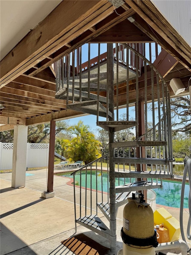 pool featuring a patio area and fence