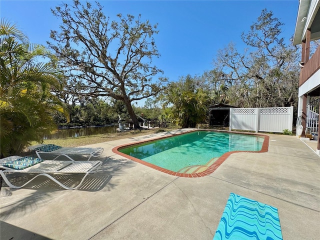 view of swimming pool with a fenced in pool, a patio, and fence