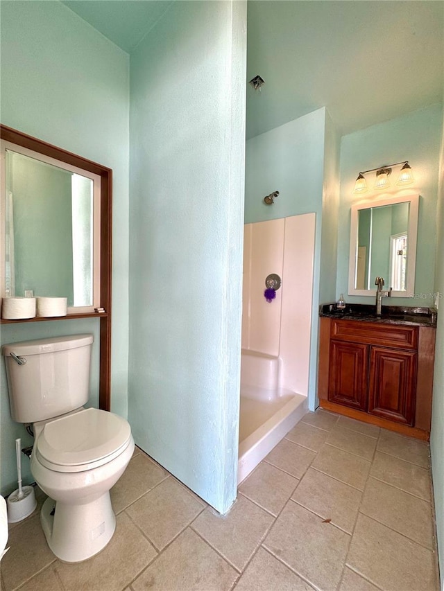 full bathroom featuring vanity, tile patterned floors, toilet, and a shower