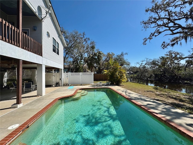 view of pool featuring a fenced in pool, a patio, a fenced backyard, and a water view