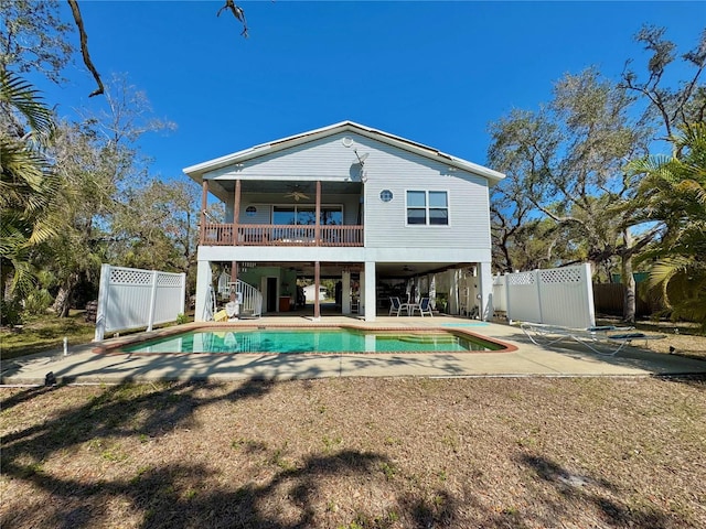 rear view of house featuring stairs, a patio, a ceiling fan, and fence