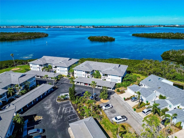 birds eye view of property with a water view and a residential view