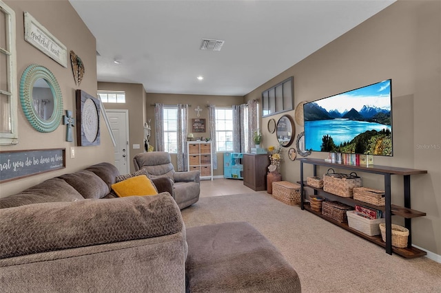 living room featuring carpet floors, visible vents, and baseboards