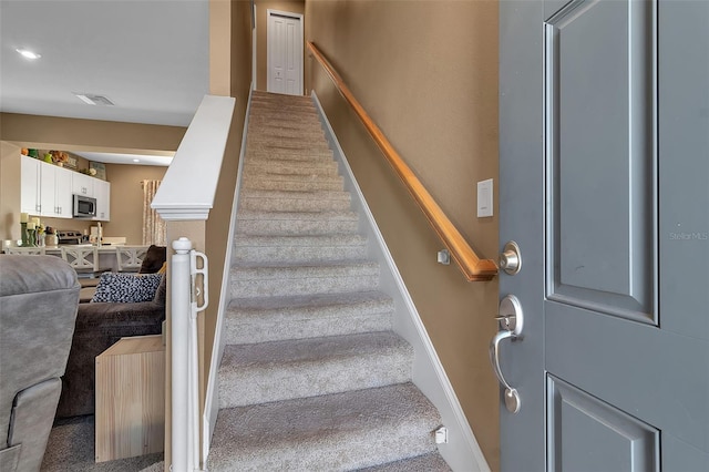 staircase featuring carpet, visible vents, and recessed lighting