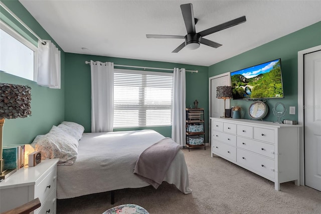 bedroom featuring a ceiling fan and light colored carpet