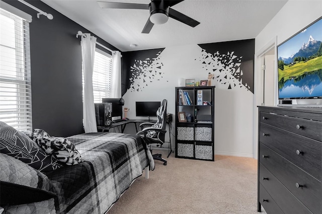 bedroom featuring light carpet, ceiling fan, and baseboards