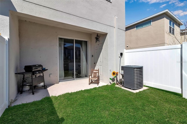 back of house featuring a lawn, fence, cooling unit, a patio area, and stucco siding