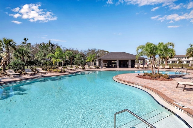 pool featuring a patio area and fence