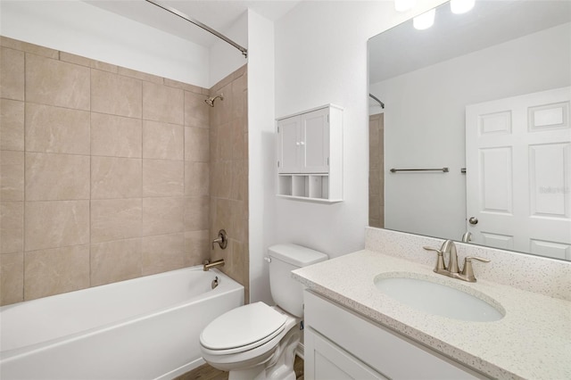 bathroom featuring vanity, toilet, and  shower combination