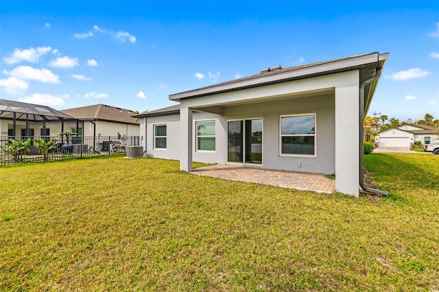 rear view of property featuring a yard, stucco siding, and fence