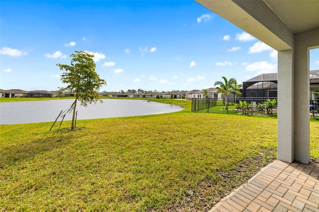 view of yard with a residential view and a water view