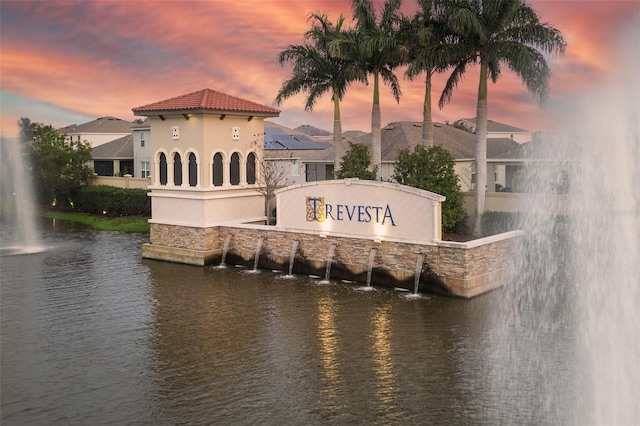 community / neighborhood sign featuring a water view