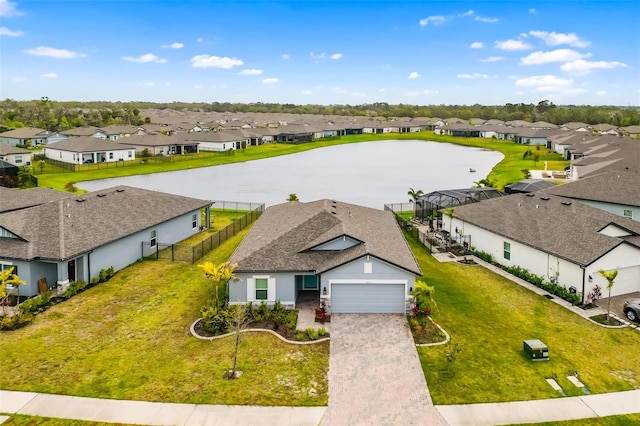 birds eye view of property with a residential view and a water view